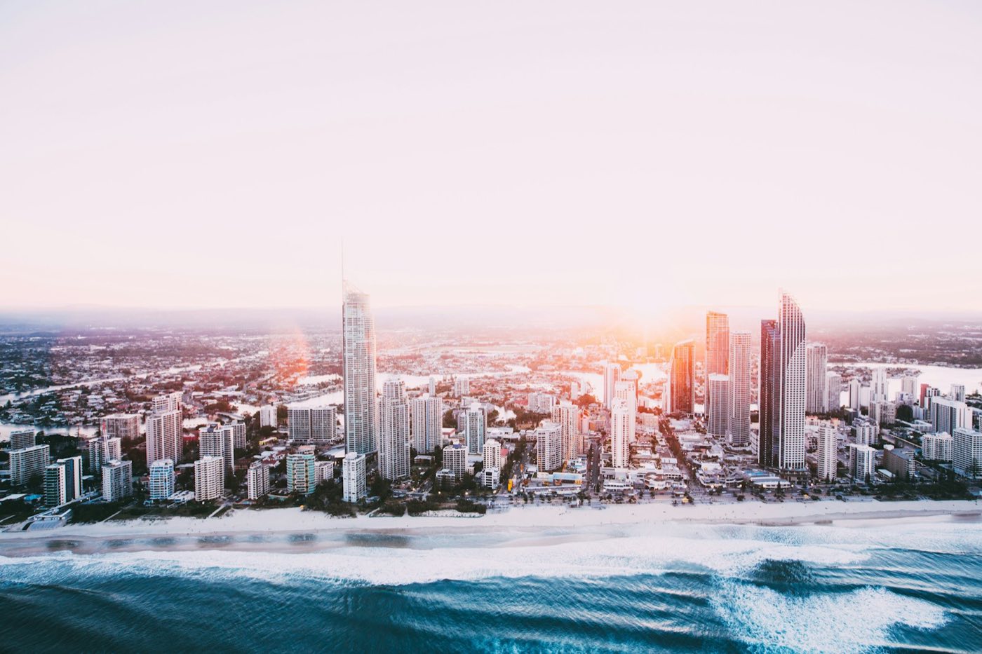 The Gold Coast skyline at dusk seen from above the beach